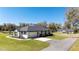 Single-story home with an attached two car garage and long driveway at 1725 W Hwy 329, Citra, FL 32113