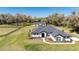 Stunning single-story home with a fenced lawn, dark roof, white siding, and manicured landscaping at 1725 W Hwy 329, Citra, FL 32113