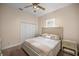 Bright bedroom with a queen bed, ceiling fan and window coverings at 5425 Se 44Th Cir, Ocala, FL 34480