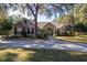 Single-story home with stone accents, landscaping, and a large driveway at 5425 Se 44Th Cir, Ocala, FL 34480