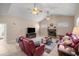 Living room with a fireplace and two ceiling fans at 5425 Se 44Th Cir, Ocala, FL 34480