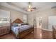 Main bedroom with king bed, hardwood floors and en-suite bathroom access at 5425 Se 44Th Cir, Ocala, FL 34480