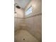 Large walk-in shower with tile surround and built-in seat at 5425 Se 44Th Cir, Ocala, FL 34480