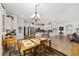 Open-concept dining area with a tile floor, seamlessly connecting to the modern kitchen and living spaces at 8706 Sw 88Th Pl, Ocala, FL 34481