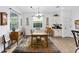 Bright dining room with a tile floor, modern chandelier, and ample natural light through a large window at 8706 Sw 88Th Pl, Ocala, FL 34481