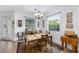 Comfortable dining area with a tile floor, large windows, and elegant chandelier at 8706 Sw 88Th Pl, Ocala, FL 34481