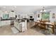 This kitchen features stainless steel appliances, granite countertops and seamless flow into the dining area at 8706 Sw 88Th Pl, Ocala, FL 34481