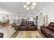 Open-concept living room showcasing a tile floor, modern furniture, and seamless flow to the kitchen and dining areas at 8706 Sw 88Th Pl, Ocala, FL 34481