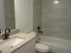 Bathroom featuring modern tiles, a granite countertop vanity, and a bathtub at 13024 Ne 6 Pl, Silver Springs, FL 34488