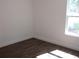 Corner of bedroom with hardwood floors and a bright window at 13024 Ne 6 Pl, Silver Springs, FL 34488