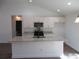 Bright kitchen featuring granite countertops, white cabinets, and a central island at 13024 Ne 6 Pl, Silver Springs, FL 34488