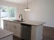 Modern kitchen island boasts granite countertops and stainless steel dishwasher at 13024 Ne 6 Pl, Silver Springs, FL 34488