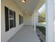 Spacious covered porch featuring sleek white columns and recessed lighting at 13024 Ne 6 Pl, Silver Springs, FL 34488