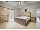 Primary bedroom with a decorative sliding barn door, and vaulted ceilings at 2880 Se 34Th St, Ocala, FL 34471