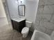 Modern bathroom featuring gray tile, a vanity with a white quartz countertop and dark brown cabinets at 3733 Se 137Th Street, Summerfield, FL 34491