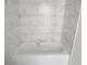Bathroom with marble-look tile and new bathtub at 3733 Se 137Th Street, Summerfield, FL 34491