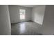 Bedroom featuring gray herringbone tile flooring, white walls and a bright window at 3733 Se 137Th Street, Summerfield, FL 34491