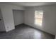 Spacious bedroom with grey herringbone tile floor and a large window at 3733 Se 137Th Street, Summerfield, FL 34491