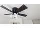Dark ceiling fan with wood-look blades and a three-bulb light fixture on a white ceiling at 3733 Se 137Th Street, Summerfield, FL 34491