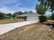 View of the front exterior shows the driveway and partial lawn at 3733 Se 137Th Street, Summerfield, FL 34491