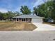 Charming one-story home featuring a two-car garage and manicured lawn on a sunny day at 3733 Se 137Th Street, Summerfield, FL 34491