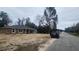 Charming single-story home with a dark roof, brown siding, and an attached garage at 3733 Se 137Th Street, Summerfield, FL 34491