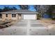 New home with stucco exterior, white trim, attached two-car garage, and new driveway at 3733 Se 137Th Street, Summerfield, FL 34491