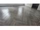 Close-up of herringbone tile flooring, highlighting its intricate pattern and contemporary style at 3733 Se 137Th Street, Summerfield, FL 34491