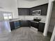 Modern kitchen with stainless steel appliances, sleek cabinetry, and bright countertops at 3733 Se 137Th Street, Summerfield, FL 34491