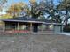 Newly built house with gray siding, brick accents, and a covered porch at 4131 Se 130Th Pl, Belleview, FL 34420