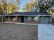 Newly constructed home with gray siding, brick accents, and a covered porch at 4131 Se 130Th Pl, Belleview, FL 34420