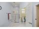 Bright bathroom featuring a glass-enclosed shower and neutral tile flooring, offering a clean and functional space at 7947 Sw 83Rd Pl, Ocala, FL 34476