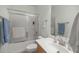 Bathroom with a shower-tub combo, sleek vanity, and a large mirror enhancing the sense of space and light at 7947 Sw 83Rd Pl, Ocala, FL 34476