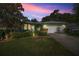 Charming single-story home with well-manicured lawn and two-car garage under a colorful sunset sky at 7947 Sw 83Rd Pl, Ocala, FL 34476