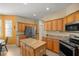 Bright and spacious kitchen features a central island, stainless steel appliances, and ample cabinet space at 7947 Sw 83Rd Pl, Ocala, FL 34476