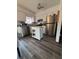 A kitchen with an island, stainless steel appliances, white cabinetry and solid surface countertops at 8152 Sw 106Th St, Ocala, FL 34481