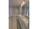 Bathroom with double vanity, white cabinets and granite countertop and shower and bathtub combo at 8309 Sw 58Th Ave, Ocala, FL 34476