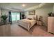 Serene bedroom with tray ceiling, soft carpet, and elegant furnishings, offering a relaxing retreat at 8309 Sw 58Th Ave, Ocala, FL 34476