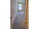 This bedroom has neutral walls, gray carpet, and a window with a white frame at 8309 Sw 58Th Ave, Ocala, FL 34476