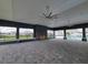 Expansive covered patio with stone fireplace, ceiling fans, and views of the pool and backyard at 8309 Sw 58Th Ave, Ocala, FL 34476