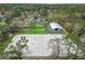 Expansive aerial view of horse training facility with riding arena, stables, pastures, and charming residence at 965 Nw 73Rd Ter, Ocala, FL 34482