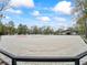Horse arena featuring sand and jump area, set against a backdrop of trees at 965 Nw 73Rd Ter, Ocala, FL 34482