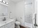 Bright bathroom features a modern vanity and a walk-in shower with elegant marble tiling at 965 Nw 73Rd Ter, Ocala, FL 34482
