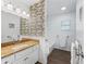 Bathroom featuring a vanity with a granite countertop and a shower-tub combo with stylish tile accents at 965 Nw 73Rd Ter, Ocala, FL 34482