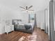 Cozy bedroom with wood floors, a ceiling fan, and neutral paint, bathed in natural light at 965 Nw 73Rd Ter, Ocala, FL 34482