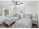 Cozy bedroom featuring matching twin beds, soft lighting, and bright windows at 965 Nw 73Rd Ter, Ocala, FL 34482
