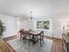 Bright dining room features a modern chandelier, a large window, and beautiful wood-look flooring at 965 Nw 73Rd Ter, Ocala, FL 34482