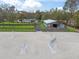 Aerial shot featuring the well-maintained horse riding arena with jumps, barn, and surrounding landscape at 965 Nw 73Rd Ter, Ocala, FL 34482