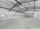Spacious garage with ample storage space and a high ceiling with exposed beams at 965 Nw 73Rd Ter, Ocala, FL 34482