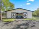 Horse barn featuring a light interior and large sliding doors and black and white trim at 965 Nw 73Rd Ter, Ocala, FL 34482